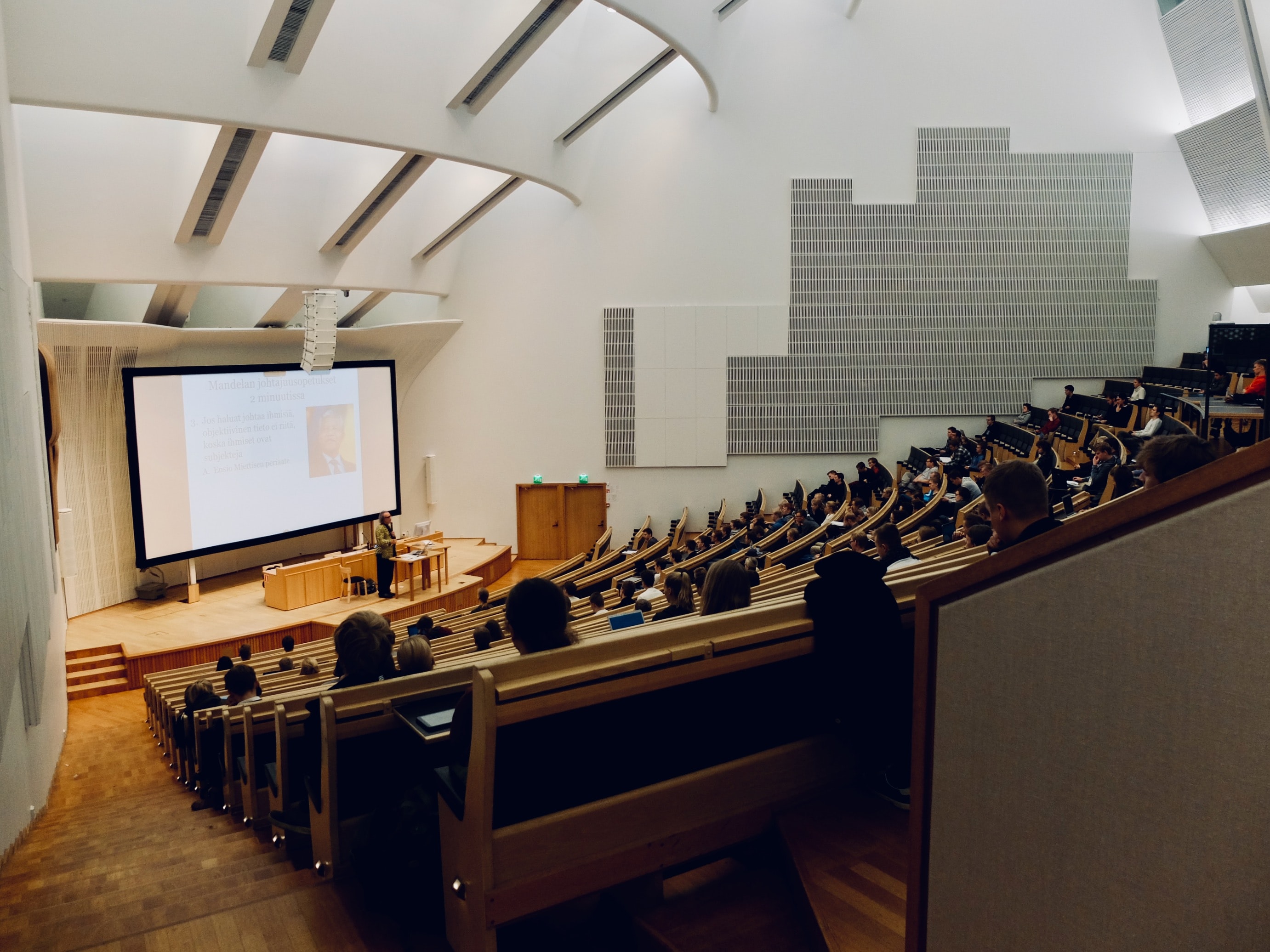 guest speaking to an auditorium of students