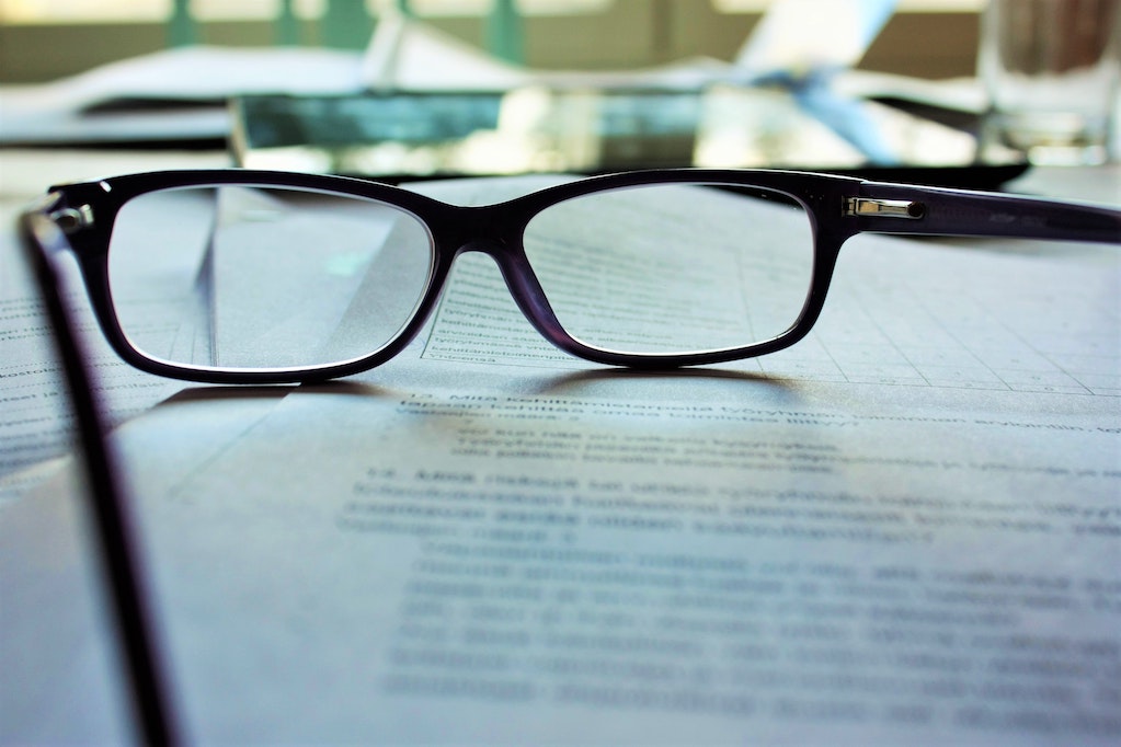 reading glasses on top of document