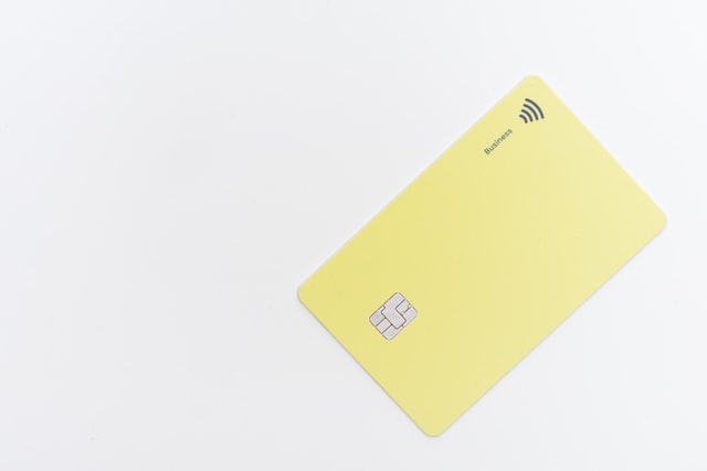 Light yellow credit card on white background 